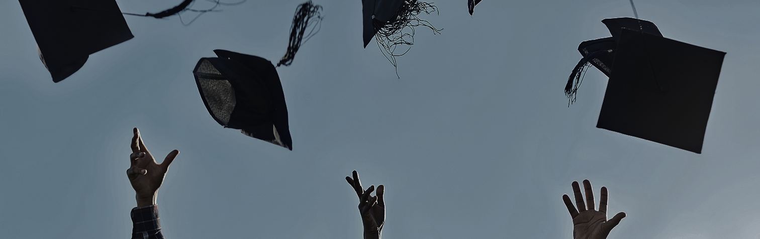 group of students throwing graduation caps