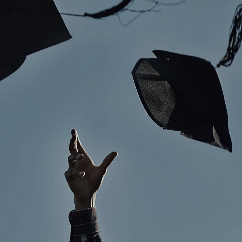 group of students throwing graduation caps