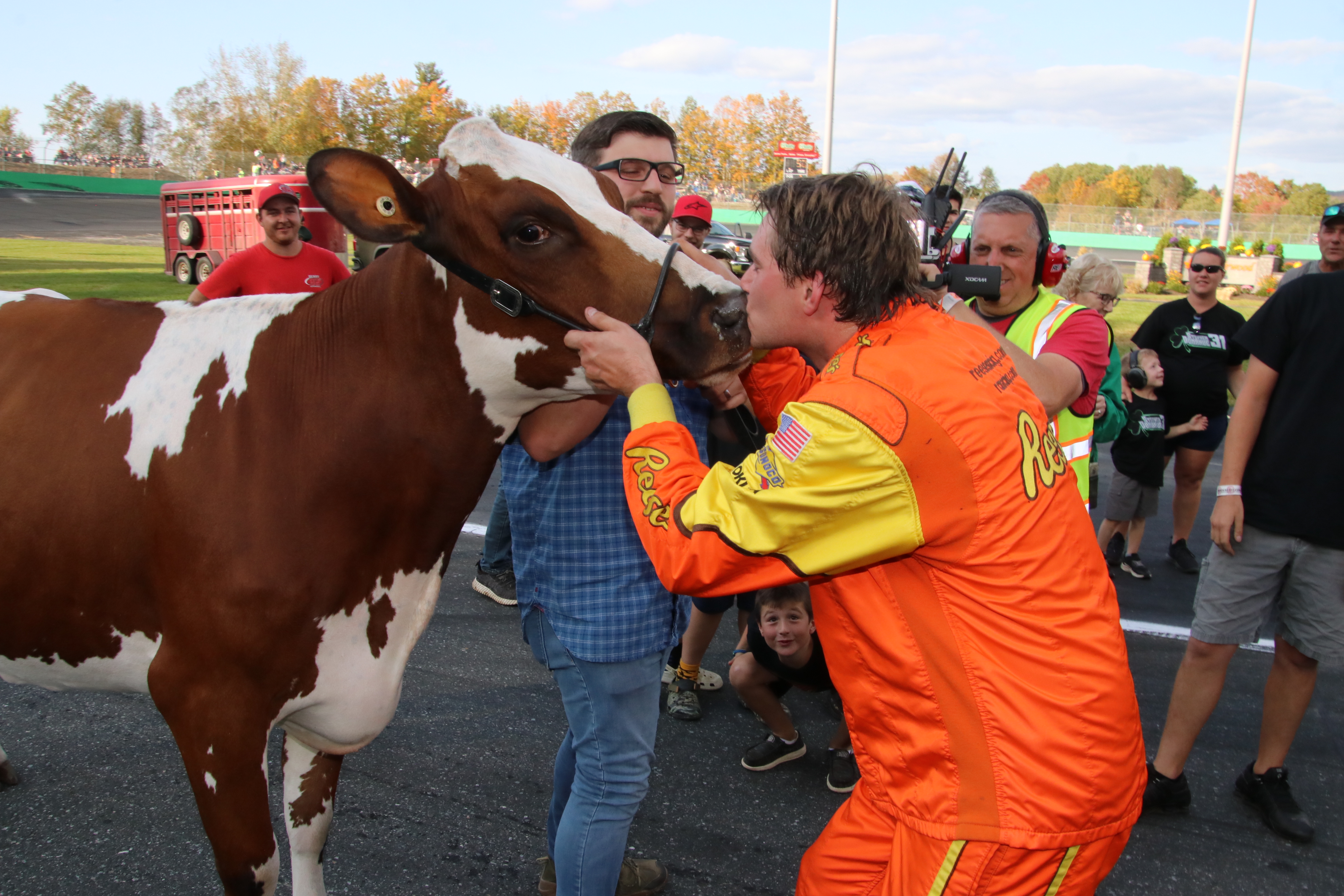 Milk Bowl winner Stephen Donahue kisses a cow.