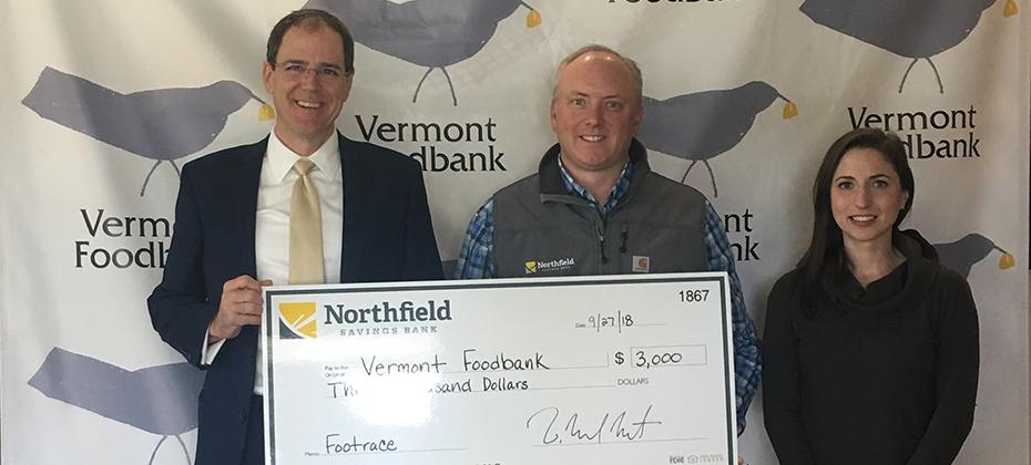 Northfield Savings Bank presents Vermont Foodbank with a check for $3,000.