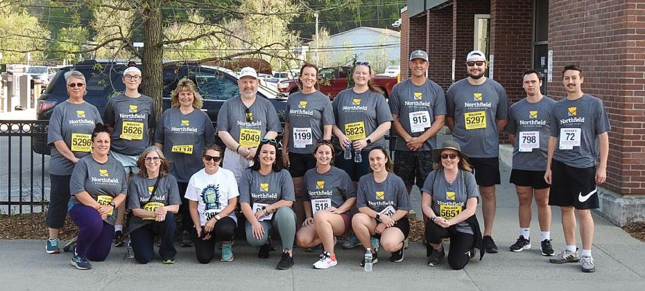 Team NSB poses for a group photo in front of the Montpelier branch before the Vermont Corporate Cup.